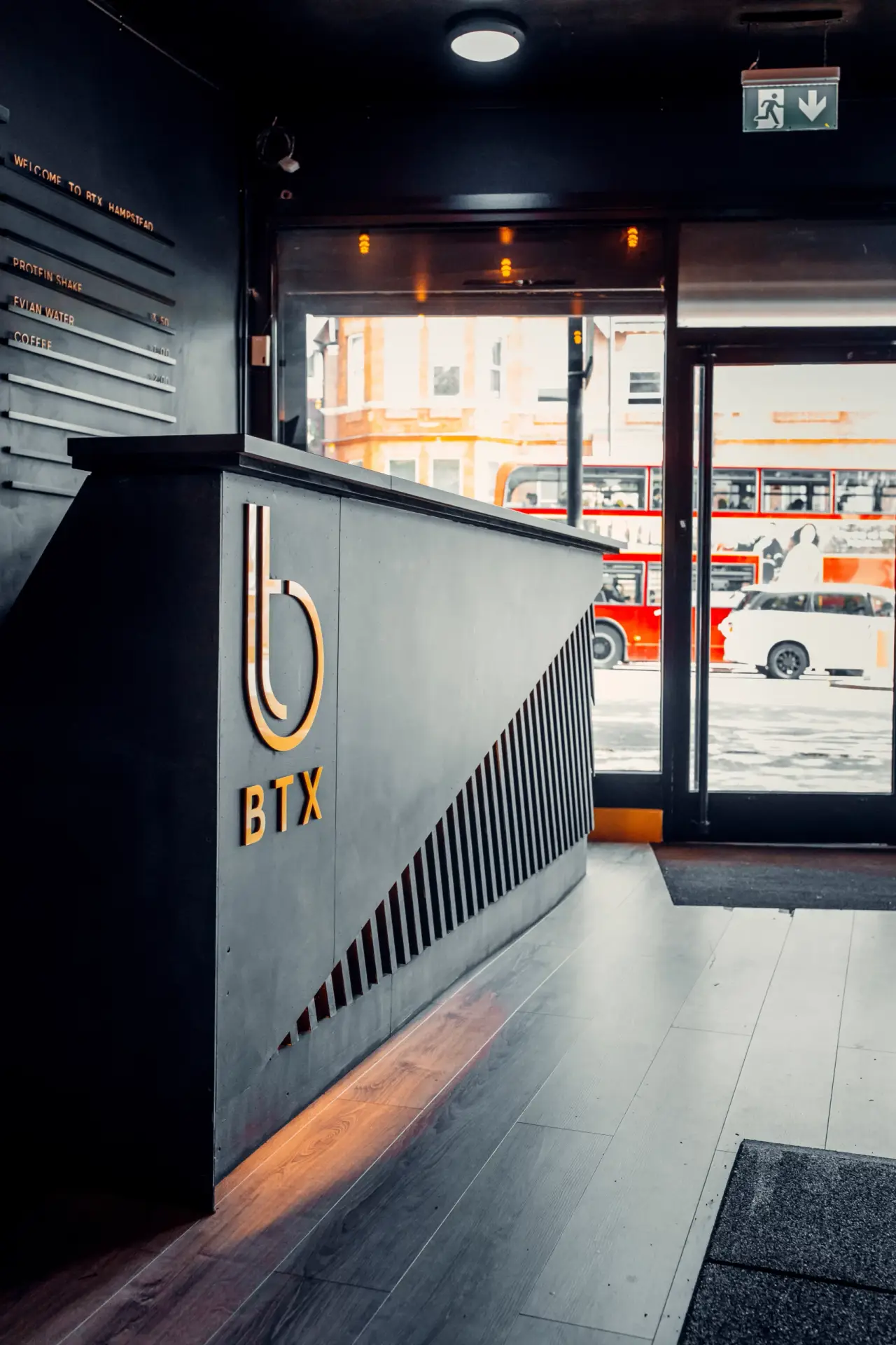 BTX reception desk with the gold logo, Finchley Road through the window